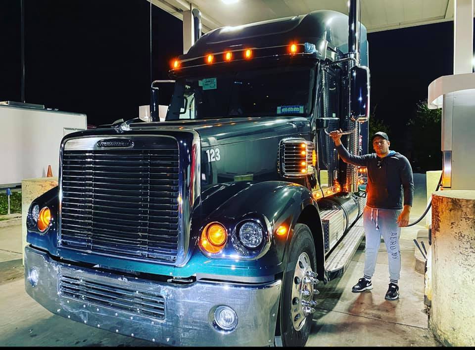 black ama logistics truck driver